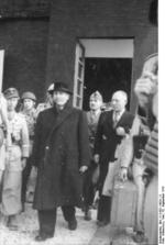 Former Italian Prime Minister Benito Mussolini and Inspector General Giuseppe Gueli being escorted out of Hotel Campo Imperatore, Gran Sasso, Italy, 12 Sep 1943, photo 2 of 2