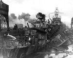 Wrecks of destroyers Downes and Cassin in Drydock One at Pearl Harbor Navy Yard, 7 Dec 1941, photo 3 of 5; note Pennsylvania in the rear