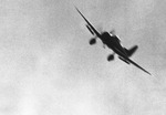 Japanese D3A dive bomber in flight over Pearl Harbor, Oahu, US Territory of Hawaii, 7 Dec 1941. Note dive brakes.