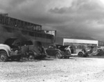 Damaged cars and hangar building at Naval Air Station Kaneohe, Oahu, US Territory of Hawaii, 7 Dec 1941