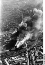 The grain silo at the intersection of Bema and Pradzynskiego Streets burning, Warsaw, Poland, Sep 1939