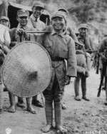 Chinese boy hired to assist troops of Chinese 39th Division during the Salween Offensive, Yunnan Province, China, 1944