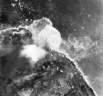 An aerial photograph of bombs exploding on the Walcheren dyke, Walcheren Island, the Netherlands during a RAF Bomber Command raid, 3 Oct 1944