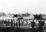 Men of the British Highland Division unloading stores on a landing beach on the opening day of the invasion of Sicily, 10 Jul 1943