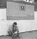 Tired member of US Navy VF-17 squadron paused under the squadron scoreboard at Bougainville, Solomon Islands, Feb 1944