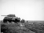 African-American troops of the 1st Bn, 24th Infantry Rgmt, US Army Americal Div behind a M4A3 Sherman tank, near Empress Augusta Bay, Bougainville, Solomon Islands, circa early 1944