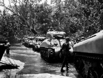 M4 Sherman tank and men of the US 1st Marine Division on the beach of Cape Gloucester, New Britain, Bismarck Archipelago, 15 Dec 1943
