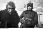 Russian soldier with PPSh-41 submachine gun guarding a wounded young German prisoner of war, Stalingrad, Russia, Jan 1943