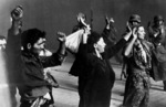 SS troops rounding up suspected Jewish resistance fighters, near intersection of Nowolipie Street and Smocza Street, Warsaw, Poland, Apr-May 1943