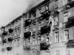Jewish man committing suicide by jumping off the top story window of the building at 23 and 25 Niska Street during the Warsaw Ghetto Uprising, Poland, Apr-May 1943, photo 1 of 2