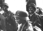 Young Polish resistance fighters in Warsaw, Poland, early morning of 2 Sep 1944, photo 2 of 2; the boy with helmet was identified as Tadeusz Rajszczak