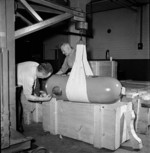 Bill Glackin and Shirley Shibley applying paint to a newly constructed torpedo warhead casing at the John Inglis factory in Toronto, Ontario, Canada, May 1944