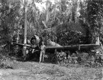 USAAF 3rd Bomb Group photographer George Tackaberry and another man with a wrecked Japanese Ki-43 fighter, Nadzab Airfield, Australian New Guinea, early 1944