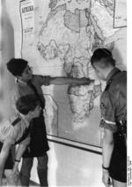 Members of the Hitler Youth studying a map of Africa, 1940