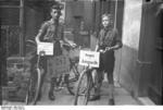 Members of the Hitler Youth with party slogan on display on their bicycles, Worms, Germany, 1930s