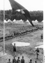 Hitler Youth members gathering on a camp ground for the Nazi Party flag raising, circa 1930s