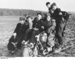 Hitler Youth members riding on a motorcycle during a visit to a German Army cavalry unit, 1944