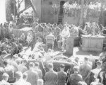 Chaplain John Craven conducting a religious service for men of US 14th Marine Regiment aboard USS Bollinger troop transport in the Pacific Ocean, Mar 1945. Note LCVP on davits upper left.