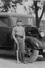 Japanese soldier posing with an automobile, circa late 1930s or early 1940s