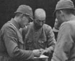 Japanese Army officers studying a map in the field, China, circa late 1937 to early 1938