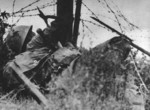 Japanese soldier negotiating barbed wire, China, late 1937 to early 1938