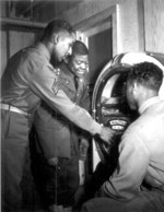 African-American US Army soldiers listening to music on a jukebox, date unknown