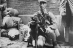 Chinese soldier with a wounded war dog, date unknown