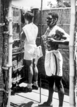 African-American US Army Sergeants William H. Whaley and Delos Oliver cleaning at the end of a day, Jul 1943