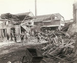 US soldiers inspecting damage done by a large caliber German artillery shell, Germany, 1944-1945