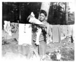 Japanese-American soldier of the 100th Infantry Battalion, 442nd Regiment, US 34th Infantry Division hanging his laundry, Chambois Sector, France, 12 Oct 1944