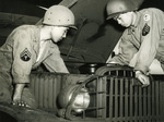 Japanese-American recruits of US 100th Infantry Battalion repairing engine of a 5x6 Army truck while training at Camp Shelby, Mississippi, United States, 1943