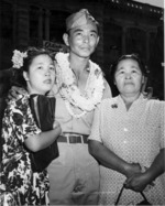 Returning Japanese-American soldier of US 442nd Regimental Combat Team weclomed by his mother and sister, Honolulu, US Territory of Hawaii, 9 Aug 1946