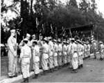 Japanese-American troops of US 442nd Regimental Combat Team presenting company guidon to Hawaii National Guard at deactivation ceremony, Kapiolani Park, Honolulu, US Territory of Hawaii, 15 Aug 1946