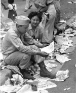 Deactivated Japanese-American soldier of US 442nd Regimental Combat Team and his girlfriend looking over discharge papers, Honolulu, US Territory of Hawaii, 15 Aug 1946