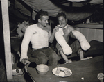 US Army Sgt. Edward F. Good feeding a fellow wounded soldier, Pfc. Lloyd Deming, a turkey leg during the Christmas dinner, 2nd Field Hospital, San Jose, Mindoro, Philippine Islands, 25 Dec 1944