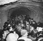 Chinese civilians seeking shelter in a cave during Japanese bombing, near Chongqing, China, circa 1939