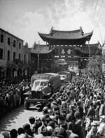 Civilians of Kunming, Yunnan Province, China watching as the first convoy across the Ledo Road arrived, early 1945, photo 2 of 2