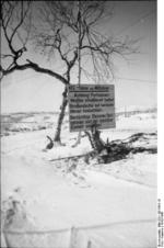 German sign warning vehicular drivers and passengers that the road lead into an area known for partisan activity and they should keep their weapons ready, Norway or Finland, 1942-1943