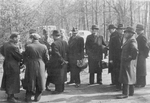 Swedish Red Cross Buses in Germany, possibly near the Friedrichsruh Manor which was the field headquarters of the Swedish Red Cross for this operation, northern Germany, 1945; most men in this photo were Gestapo members who were ordered to follow the busses