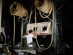 A worker of the North American Aviation factory in Inglewood, California, United States operating a drop hammer that made sheet metal parts for aircraft production, Oct 1942