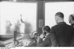 Men working at the German 4. Flakdivision headquarters in Germany, spring 1944; note translucent wall map