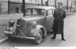 German Sturmführer Zwiebel posing with an official automobile in Riga, Latvia, 7 Mar 1943