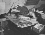 USAAF man working on aerial reconnaissance photographs, Saipan, Mariana Islands, 1945, photo 2 of 2
