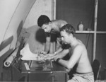 USAAF men working on aerial reconnaissance photographs, Saipan, Mariana Islands, 1945, photo 3 of 4