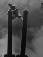 A Japanese sailor performing maintenance on naval guns, 1941-1943