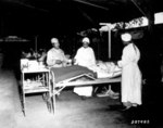 African-American US Army nurses 2nd Lt Prudence Burns, 2nd Lt Elcena Townscent, and a 3rd nurse treating Sgt Lawrence McKreever at 268th Station Hospital, Base A, Milne Bay, New Guinea, 22 Jun 1944