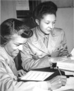 African-American US Army WAAC Lieutenants Harriet West and Irma Clayton working on a recruitment schedule report, Temp Bldg M of WAAC Headquarters, 26th St, Washington, DC, United States, 1942