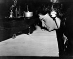 WAVES Specialist (Teacher) Sheila Macksey checking a radio range chart, while serving as a Link trainer instructor at Naval Air Station, St. Louis, Missouri, United States, circa 1943