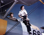 WAVES Parachute Rigger 3rd Class Lorna Peterson climbing out of a N2S training plane after her orientation flight with Lieutenant (jg) Keith W. Sharer, Ottumwa, Iowa, United States, circa 1944-1945