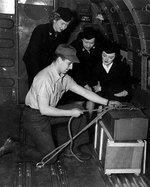 Aviation Metalsmith J. J. Lombardo showing WAVES personnel how to tie down cargo, Naval Air Transport Service School, Naval Air Station, Oakland, California, United States, 17 Feb 1945